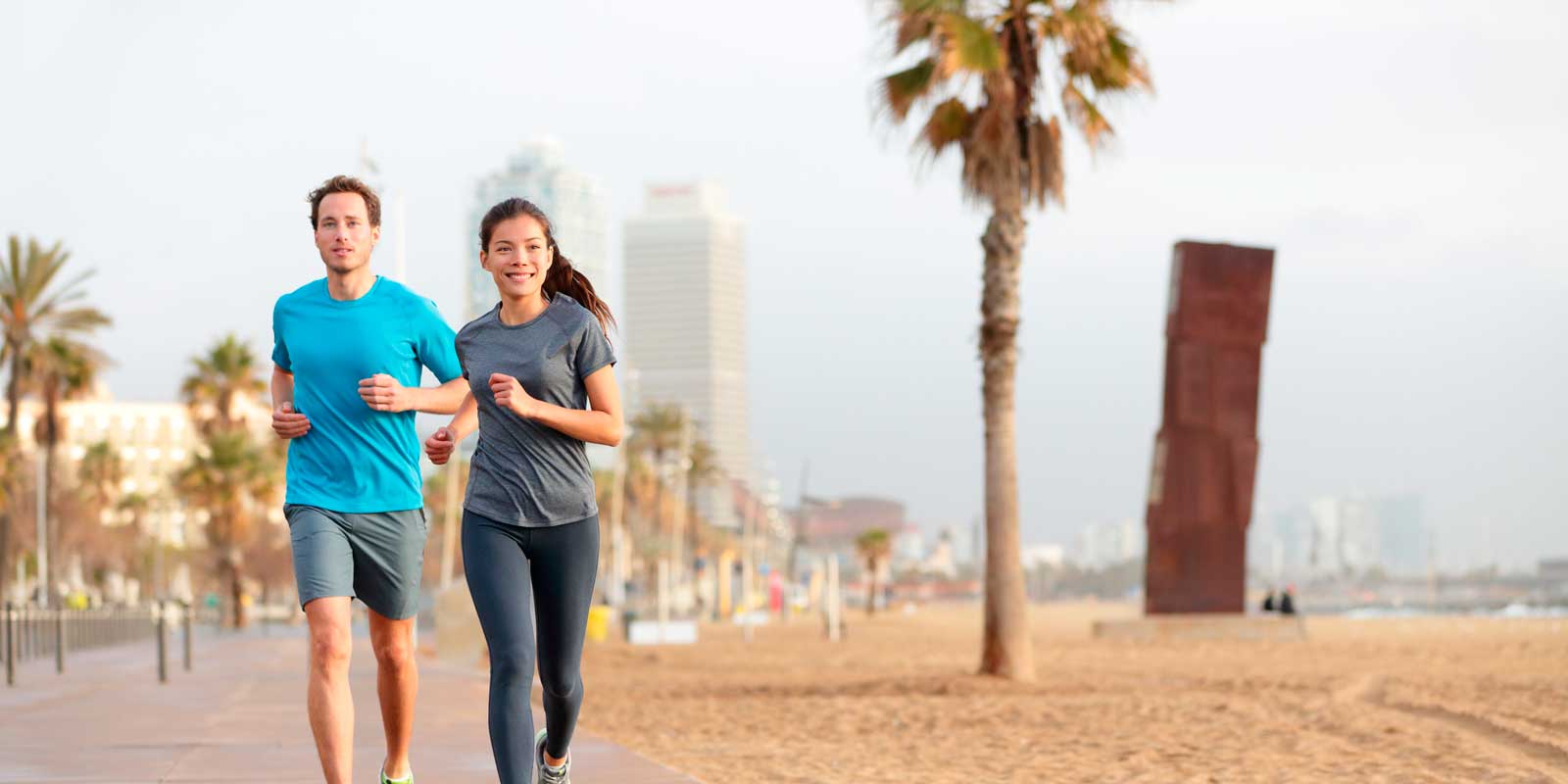 Running woman jogging on Barcelona Beach, Barceloneta. Healthy